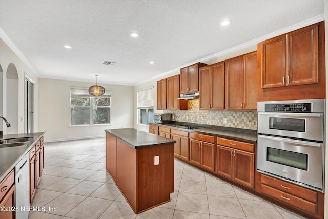 kitchen featuring double oven, decorative light fixtures, dishwasher, sink, and a center island