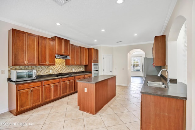 kitchen featuring extractor fan, light tile patterned flooring, tasteful backsplash, sink, and ornamental molding