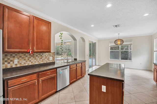 kitchen featuring sink, light tile patterned floors, dishwasher, hanging light fixtures, and tasteful backsplash