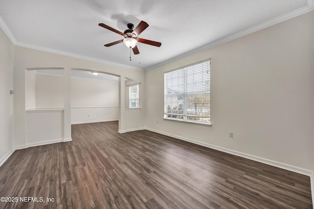 spare room with ornamental molding, dark wood-type flooring, and ceiling fan