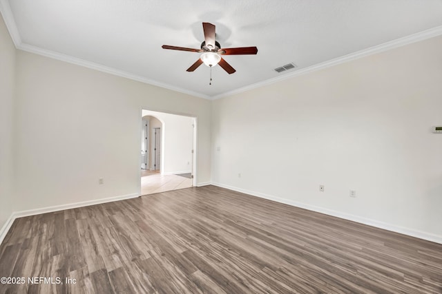 empty room with ceiling fan, ornamental molding, and light hardwood / wood-style floors