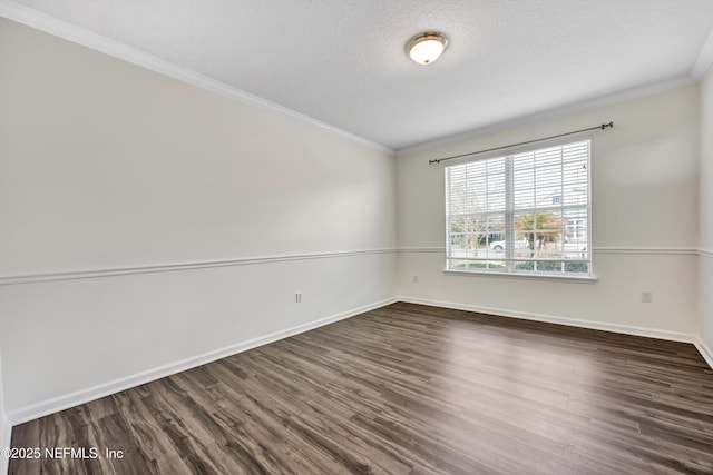 spare room with dark wood-type flooring, crown molding, and a textured ceiling