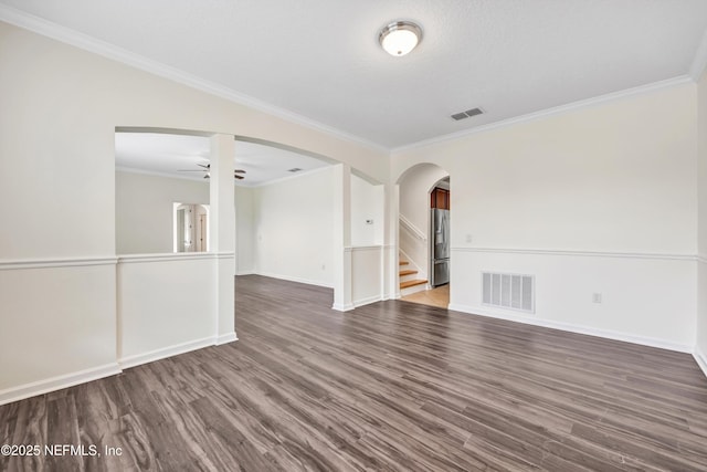 unfurnished room featuring crown molding, ceiling fan, dark hardwood / wood-style flooring, and a textured ceiling