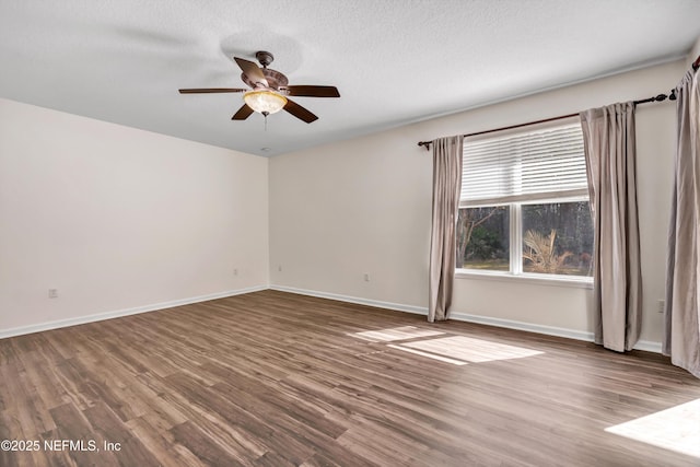 spare room with hardwood / wood-style floors, a textured ceiling, and ceiling fan