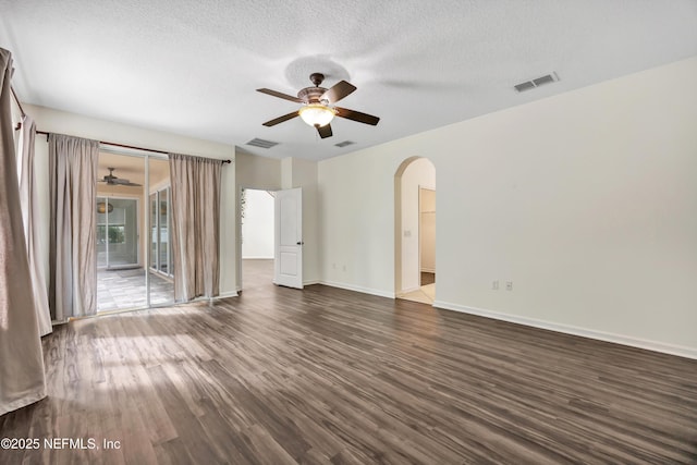 empty room featuring ceiling fan, dark hardwood / wood-style flooring, and a textured ceiling