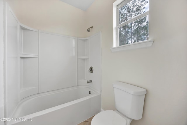 bathroom featuring toilet and shower / bathing tub combination