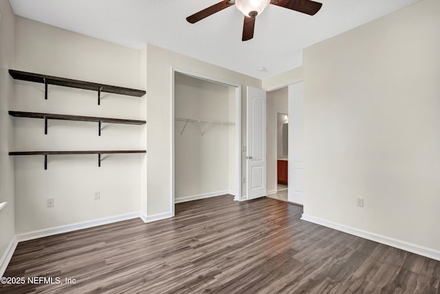 unfurnished bedroom featuring dark hardwood / wood-style floors, ceiling fan, and a closet