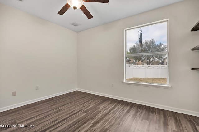 spare room featuring dark hardwood / wood-style flooring and ceiling fan