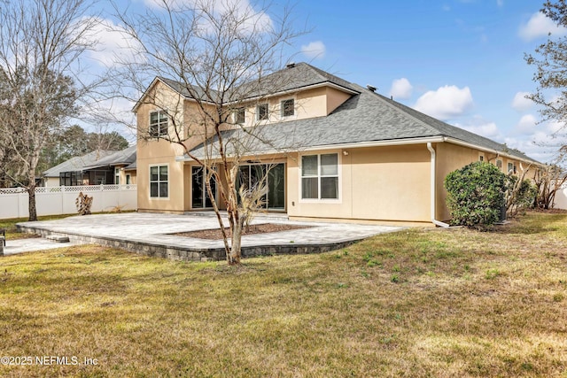 rear view of property featuring a yard and a patio area