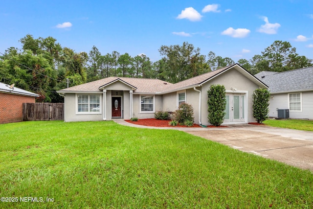 single story home with a front yard, french doors, and central AC