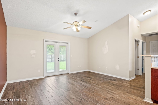 spare room with a textured ceiling, ceiling fan, french doors, and vaulted ceiling