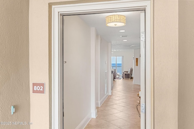 hallway featuring light tile patterned floors