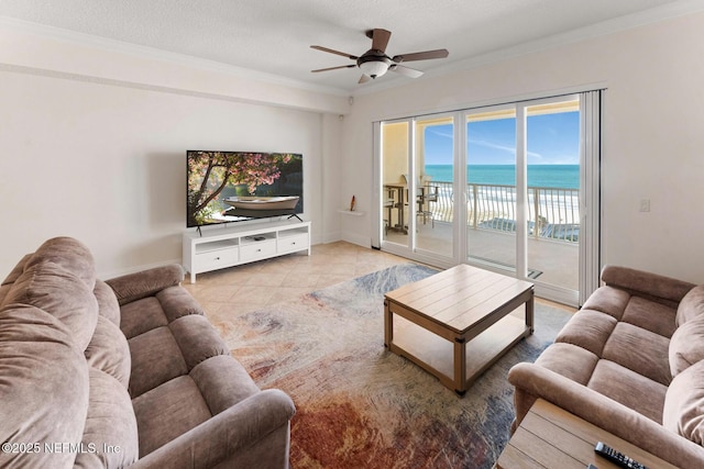 tiled living room featuring a textured ceiling, ceiling fan, and crown molding