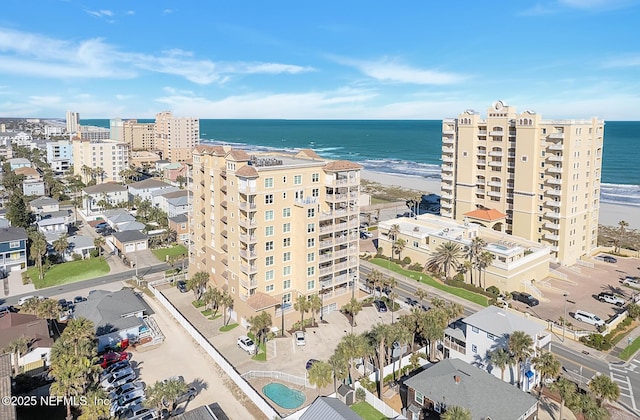 bird's eye view with a water view and a beach view