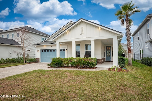 view of front of home featuring a porch, a front lawn, and a garage