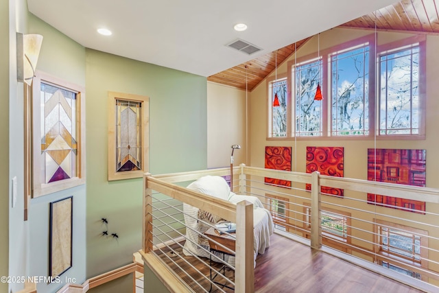 bedroom with vaulted ceiling, hardwood / wood-style floors, and wood ceiling