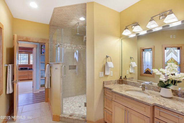 bathroom featuring vanity, an enclosed shower, and tile patterned flooring