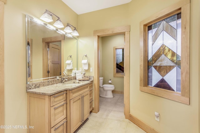 bathroom with vanity, tile patterned floors, and toilet