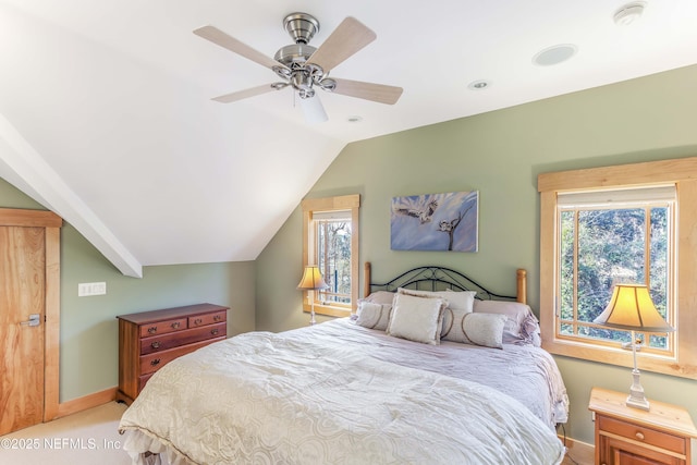 bedroom with lofted ceiling, light colored carpet, and ceiling fan