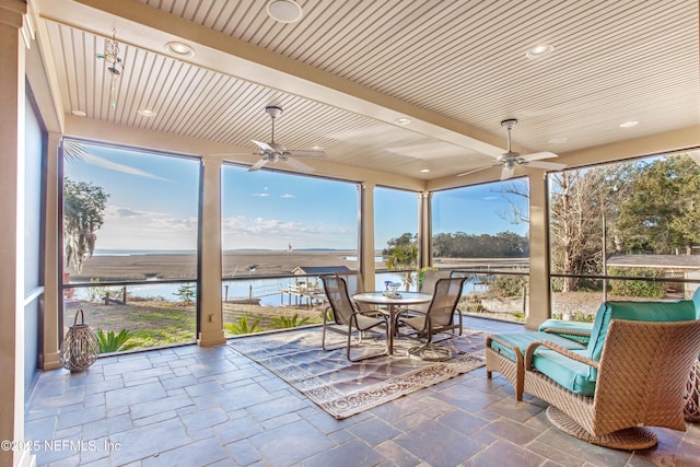 sunroom / solarium featuring a water view, ceiling fan, and wood ceiling