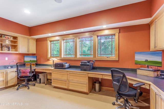 carpeted office space featuring built in desk