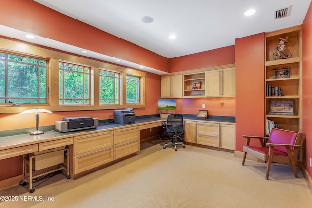 carpeted office featuring built in desk