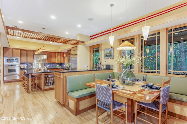 dining room featuring sink and light wood-type flooring