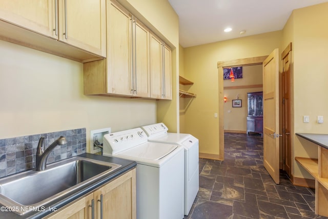 laundry room featuring cabinets, sink, and washing machine and clothes dryer