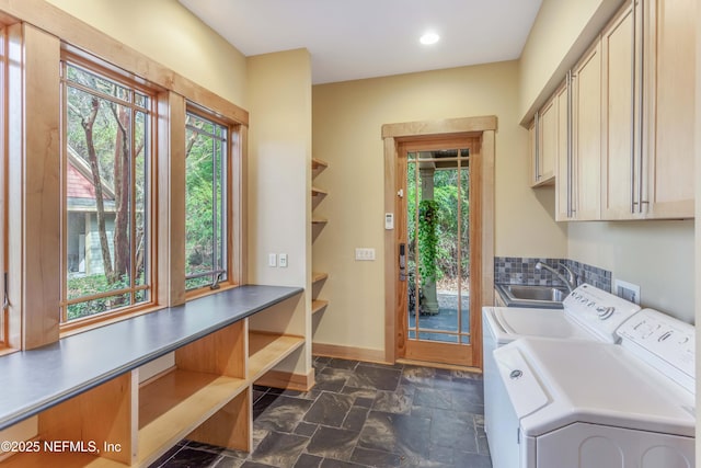 laundry area with cabinets, plenty of natural light, sink, and washing machine and dryer