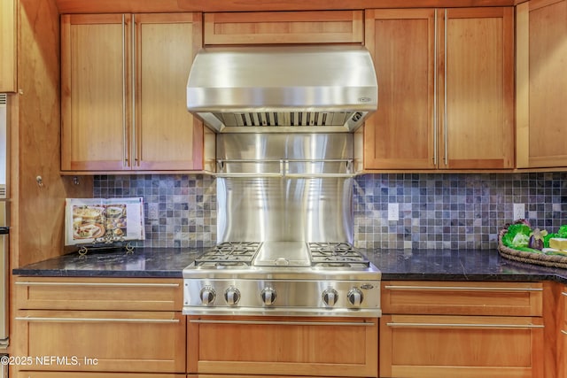 kitchen with decorative backsplash, exhaust hood, and dark stone counters