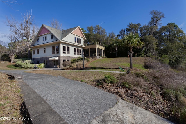 view of front of property featuring a sunroom and a front yard