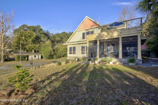 view of front of property featuring a balcony, covered porch, and a front yard