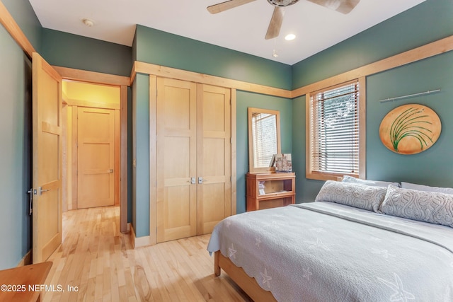 bedroom featuring a closet, ceiling fan, and light wood-type flooring