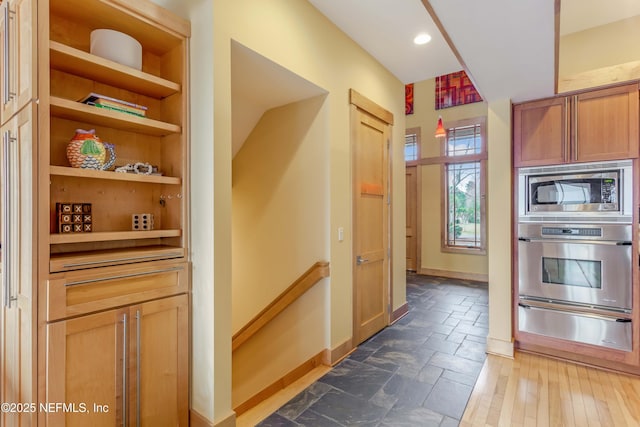 kitchen featuring appliances with stainless steel finishes and built in shelves