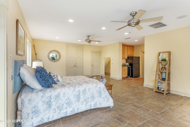 bedroom featuring black refrigerator and ceiling fan