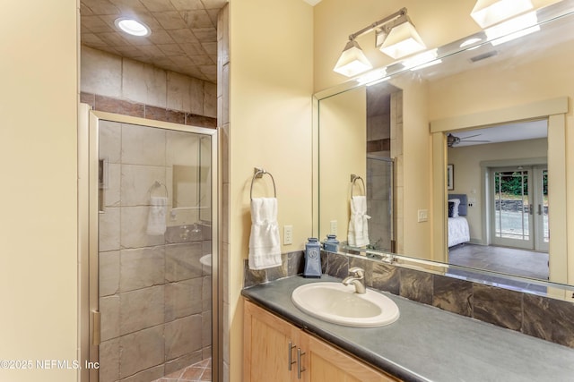 bathroom featuring walk in shower and vanity