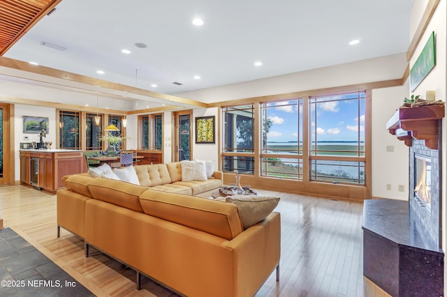 living room featuring light hardwood / wood-style flooring and a high end fireplace