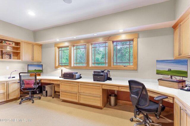 carpeted home office with built in desk