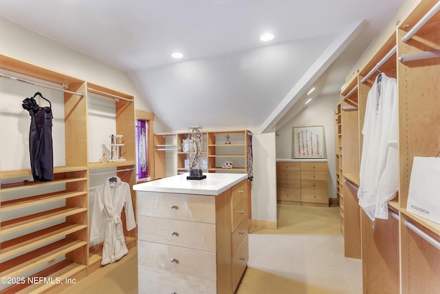 walk in closet featuring lofted ceiling and light colored carpet