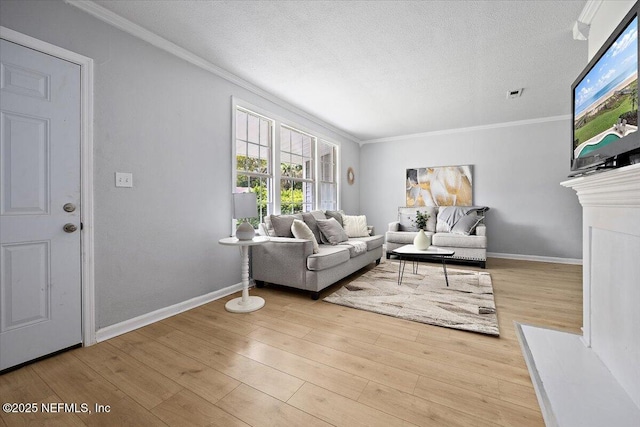 living room with a textured ceiling, light hardwood / wood-style flooring, and crown molding