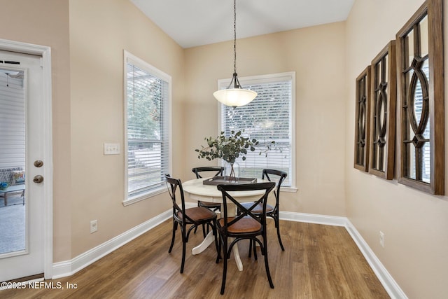 dining space featuring wood-type flooring