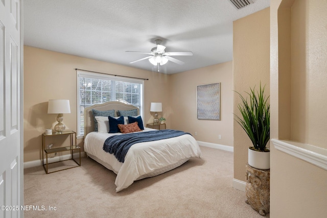 carpeted bedroom featuring a textured ceiling and ceiling fan