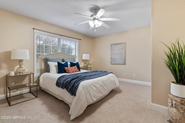 bedroom featuring ceiling fan and light carpet