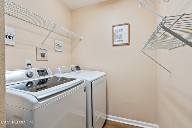 washroom with washing machine and dryer and dark hardwood / wood-style flooring