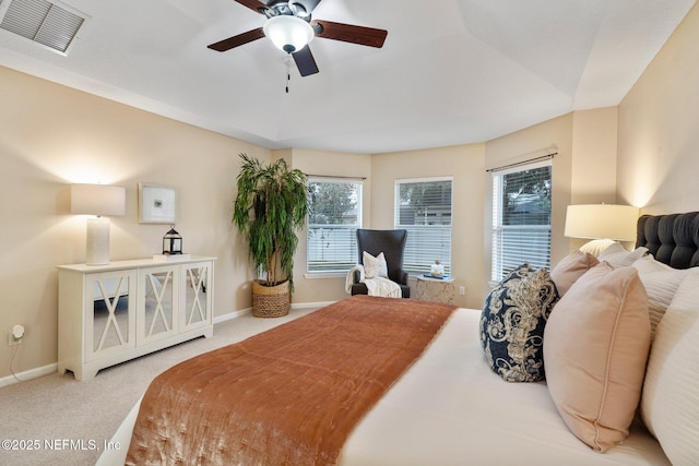 carpeted bedroom with multiple windows and ceiling fan