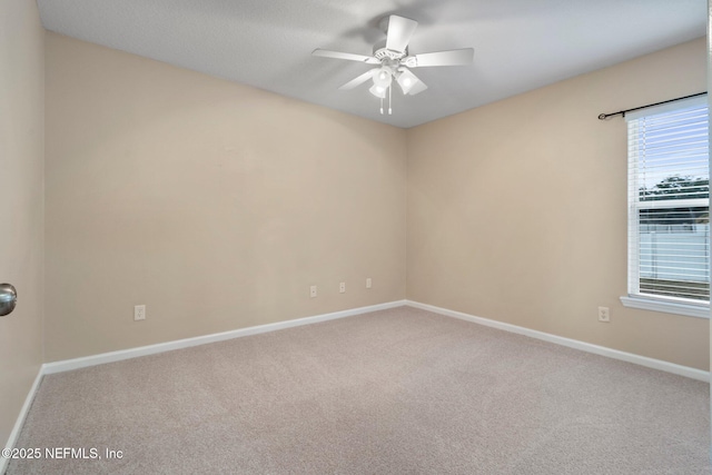 spare room featuring carpet flooring and ceiling fan