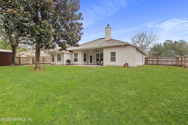 back of house with a patio area, ceiling fan, and a yard