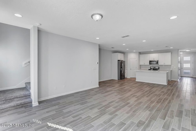 unfurnished living room with light hardwood / wood-style flooring