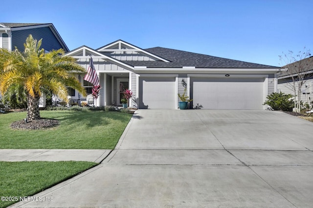 view of front facade featuring a front yard and a garage