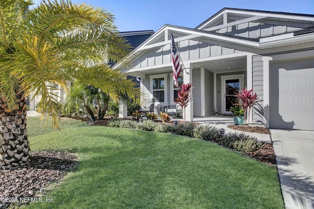 view of home's exterior featuring covered porch, a yard, and a garage